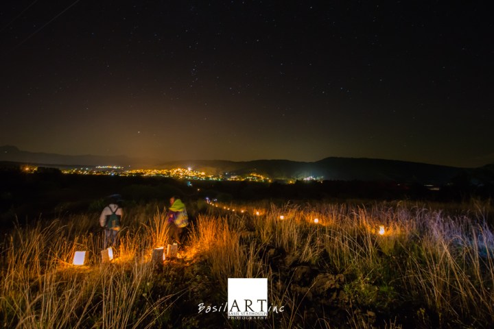 A line of lanterns leading a straight line to the village.